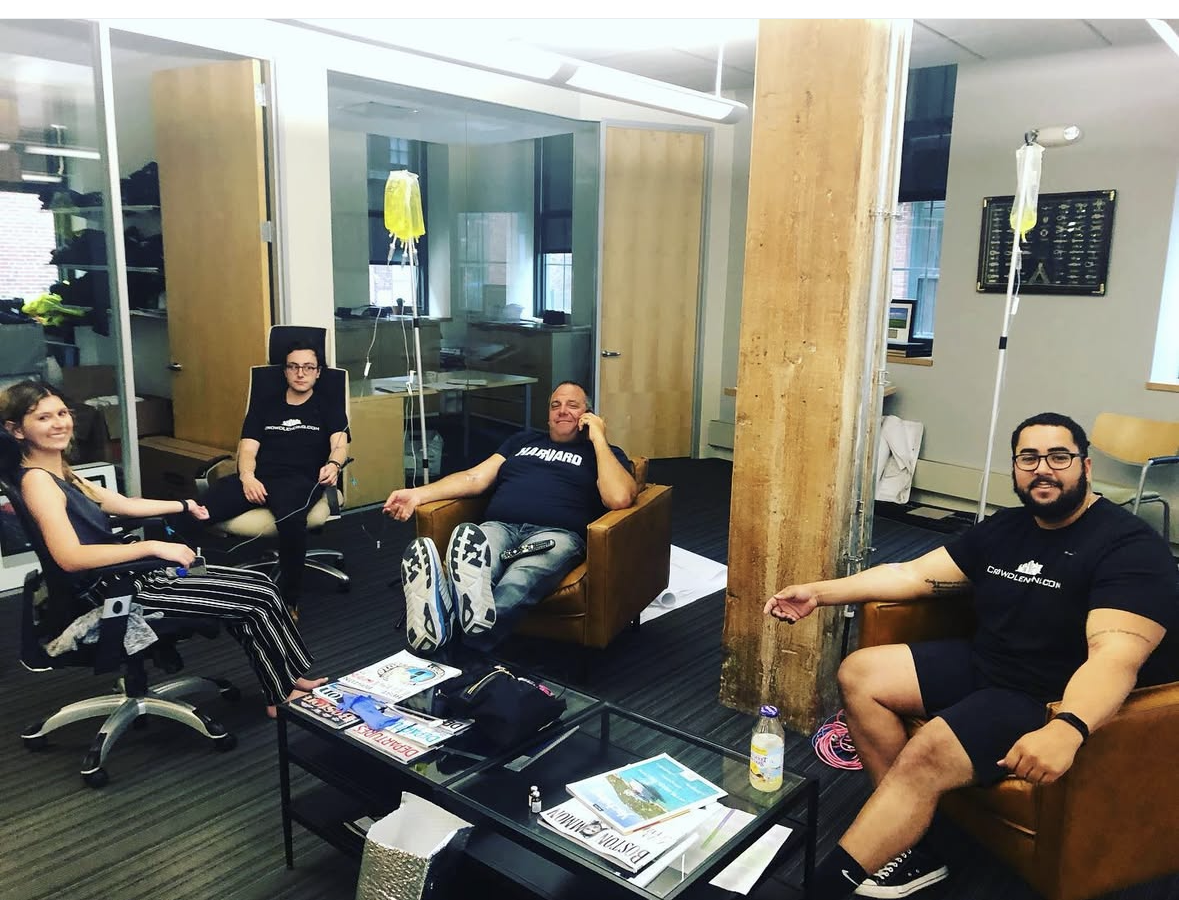 Corporate team receiving IV therapy at their Boston office during a wellness day