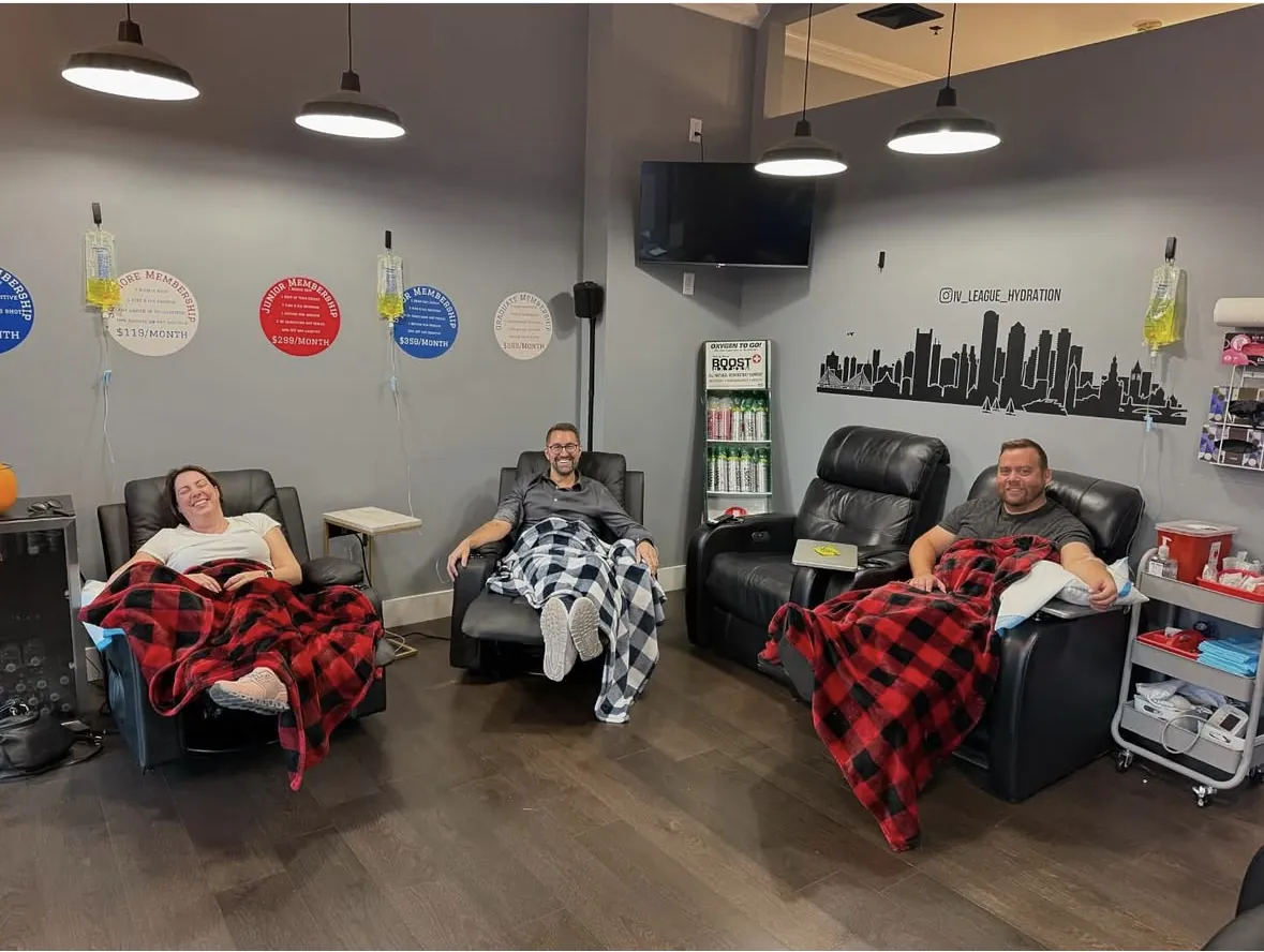 Clients relaxing in leather recliners during IV drips at the IV League Hydration L Street clinic in South Boston
