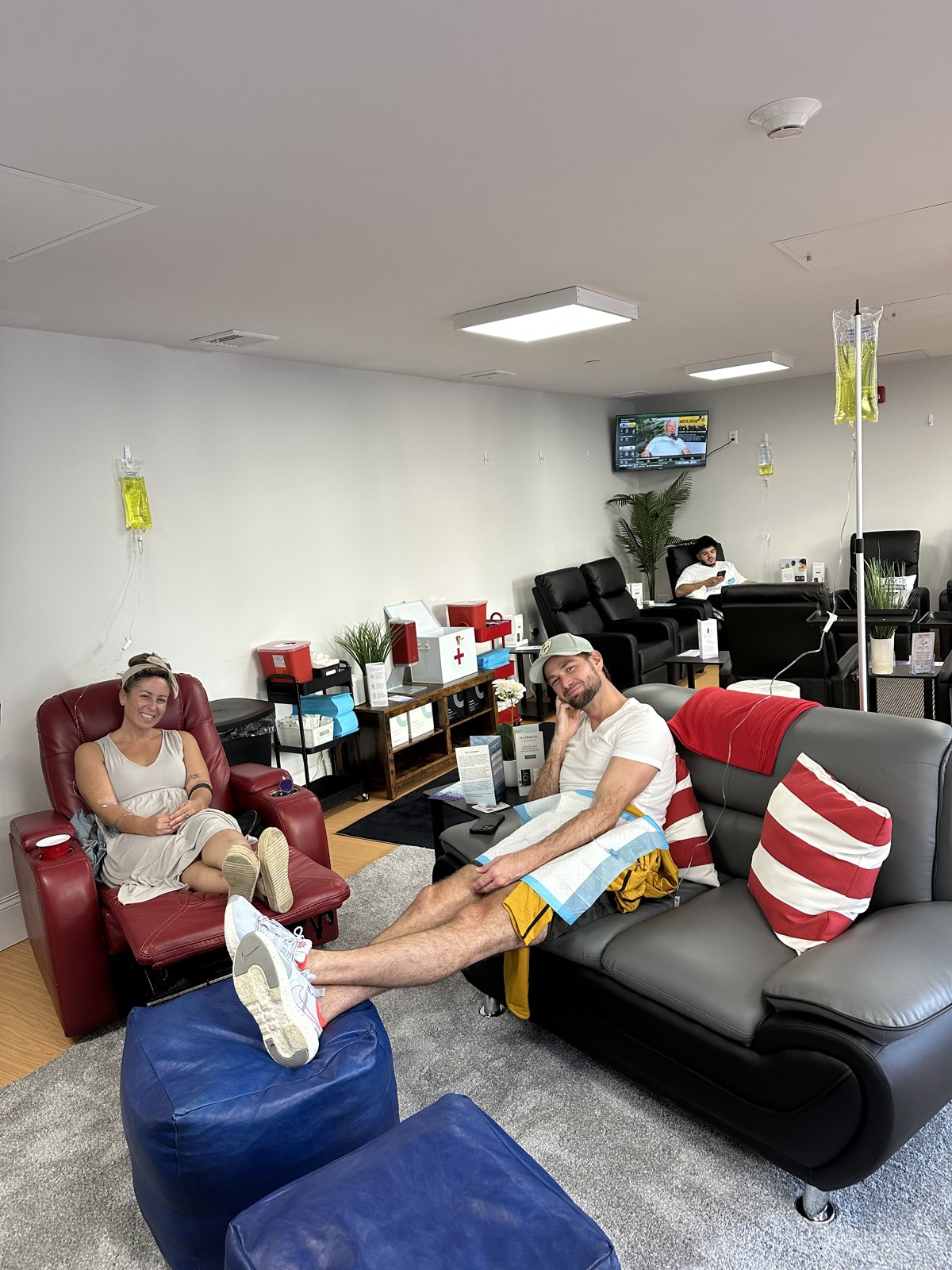 Clients relaxing in recliners during vitamin IV therapy at the Boston hydration lounge